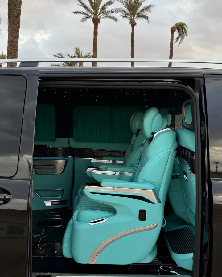 Mercedes-Benz V-Class Maybach with its sliding door open, palm trees behind